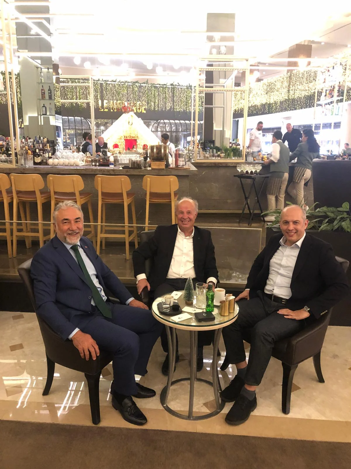 Eugen Mesares and Cahit Şahin seated with a business contact in a lounge