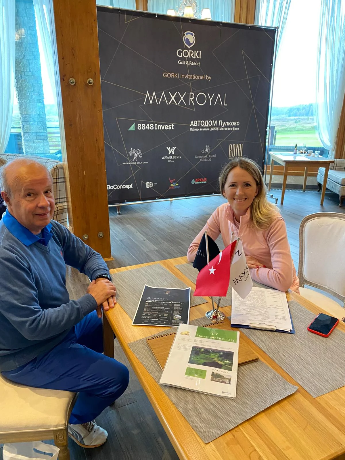 Eugen Mesares at a Maxx Royal golf meeting with Turkish flags on the table